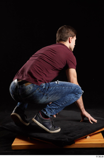 Tomas Salek 1 blue jeans dressed grey shoes kneeling red…